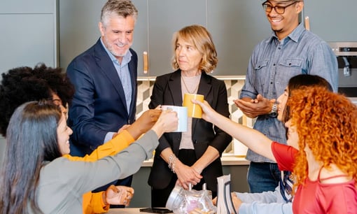 Coworkers engaging during a break, representing how employee recognition strengthens team morale, boosts productivity, and supports business growth.
