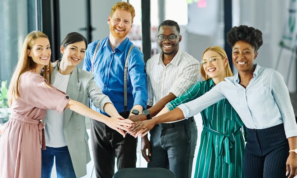  Portrait of a motivated MSP team collaborating in the office, demonstrating engagement, ownership, and teamwork in a professional setting.