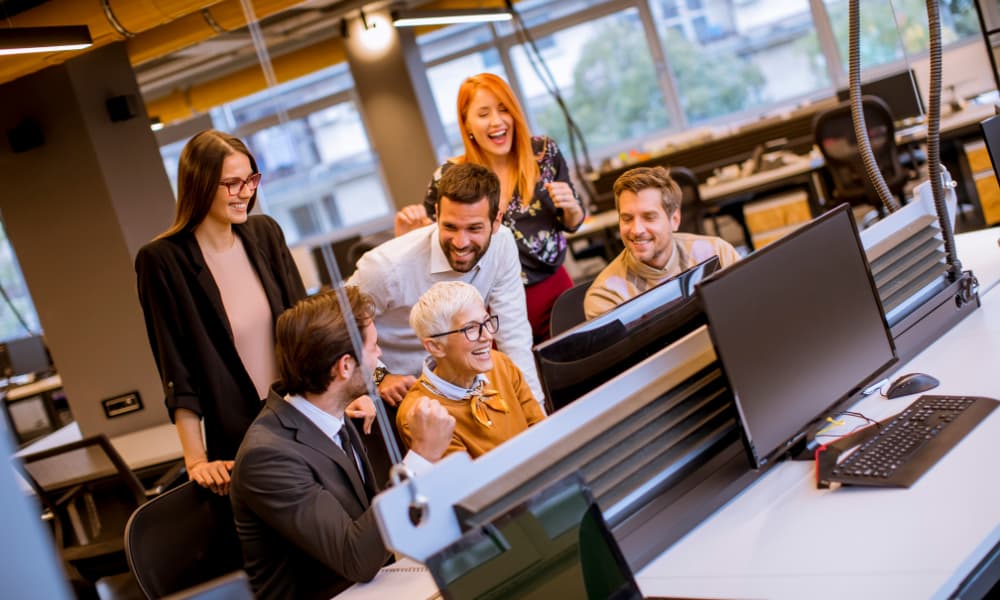 Coworkers engaging during a break, representing how employee recognition strengthens team morale, boosts productivity, and supports business growth.