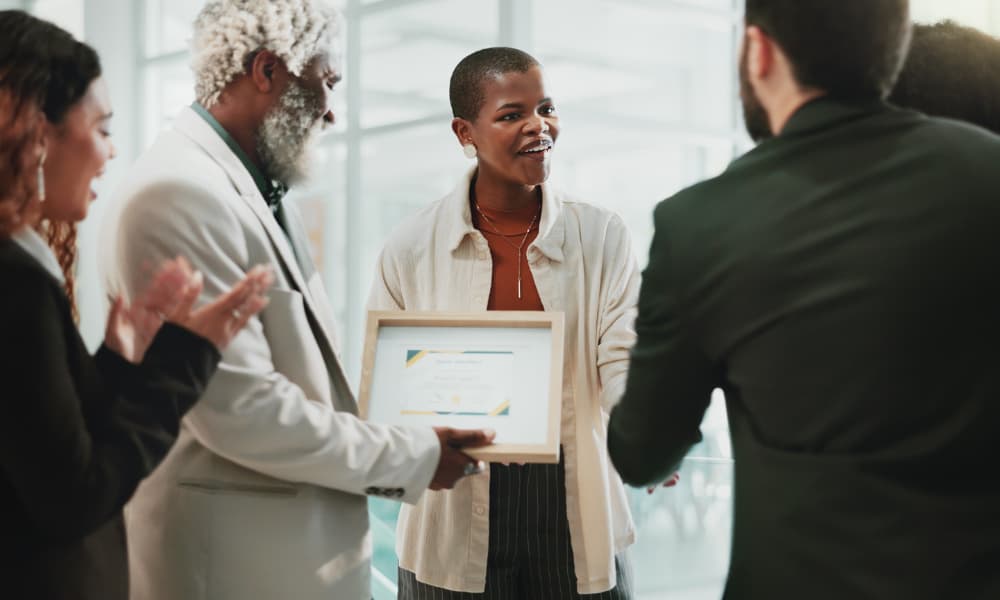 Business people, applause and celebration in the office for a certificate, achievement and development.