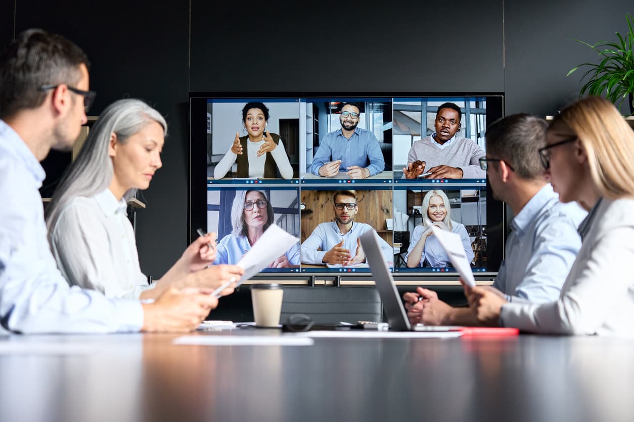 Employees at an office on their first day of working as a hybrid team.