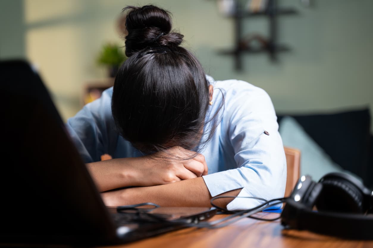 A female operations team employee suffering from burnout.