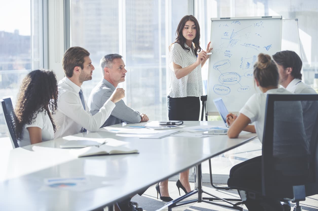 Employees having a discussion with their team leader following employee surveys